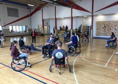 Family members playing wheelchair basketball